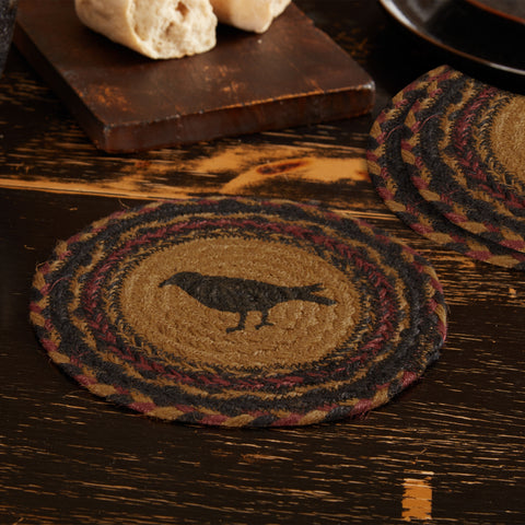 Heirloom Farm Crow Braided Trivet 8" Set of 3 Round woven trivet with black crow design on a wooden surface