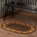 Blackstone Farm Star braided oval rug in black and tan jute with center star design in a country-style interior