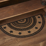 Blackstone Farm Star braided half-circle rug in black and tan jute with stenciled star border placed at base of wood staircase