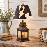 Small black lantern lamp with Holstein shade in farmhouse setting