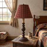 The lamp on a nightstand in a primitive bedroom