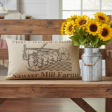 Farmstead Charcoal Plow Harvest Throw Pillow 22x14 styled on a wood bench in a farmhouse living room with a galvanized milk can container of sunflowers.