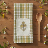 Sage & Mustard Plaid Dishtowel with floral embroidery on a wood table with a wood spoon an daisy flowers.