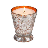 Fleur de Lys Tangerine Tumbler Hand-Poured Soy Scented Candle in a textured, footed glass holder with a distressed silver and copper-orange finish, set against a plain white background.