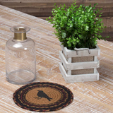 Heirloom Farm Crow Braided Trivet 8" Set of 3 on a white farmhouse table with a wood container of plant greenery