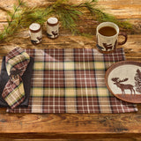 Wooden table setting with Friar Brown Plaid Cotton Cloth Napkins Set of 4 and placemat with moose napkin ring on a wooden surface with moose and bear salt and pepper shakers. runner, moose-themed mug, salt and pepper shakers, and decorative plate.