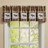 Friar Brown Plaid Moose Patch Valance with moose designs above a window with a view of trees.