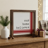 Our Home Believes Vintage Christmas Sign in a cozy console-table setting
