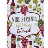 A square kitchen towel CLOSE UP with a white background printed with wine bottles, clusters of red and green grapes, and a central decorative label that reads “WINE & FRIENDS ARE A GREAT blend.”.
