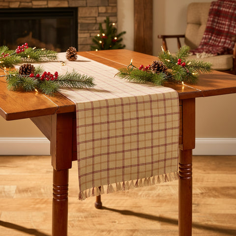 Simmons plaid table runner styled with Christmascenterpiece on farmhouse dining table
