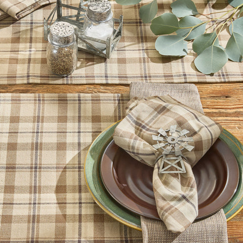 Tinderbox Brown Plaid Cloth Napkin folded on a brown stoneware plate with a galvanized windmill napkin ring, plaid placemat, galvanized salt and pepper shakers, and eucalyptus — farmhouse table setting