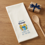 Being My Sister Dishtowel on a wood table with a gift and wooden spoon