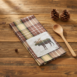 Friar Brown Plaid Moose Dishtowel on a wood table with wood spoon and pinecones