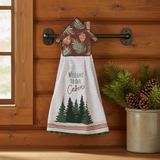 Log cabin kitchen lifestyle image with pine greenery and Welcome to our Cabin Hang-Up Towel